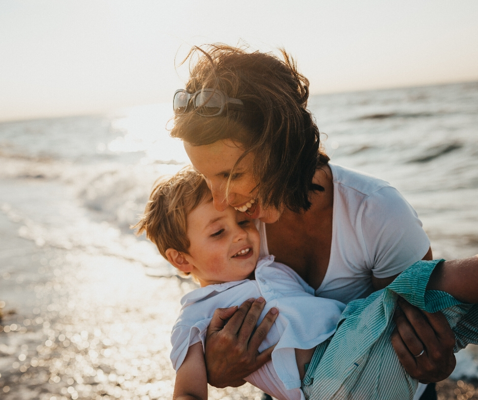 Woman Holding Son At Beach Woman Holding Son At Beach