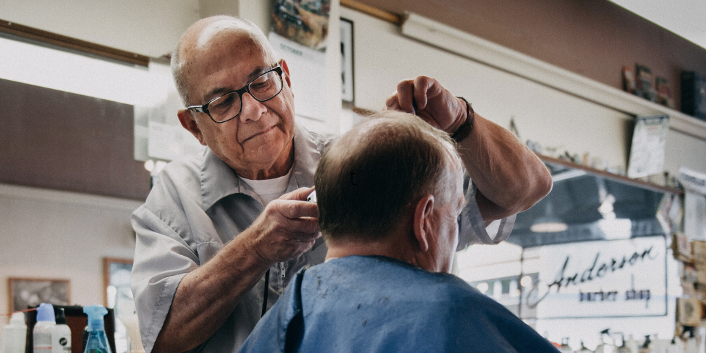 Man Getting Haircut At Barber Shop Man Getting Haircut At Barber Shop